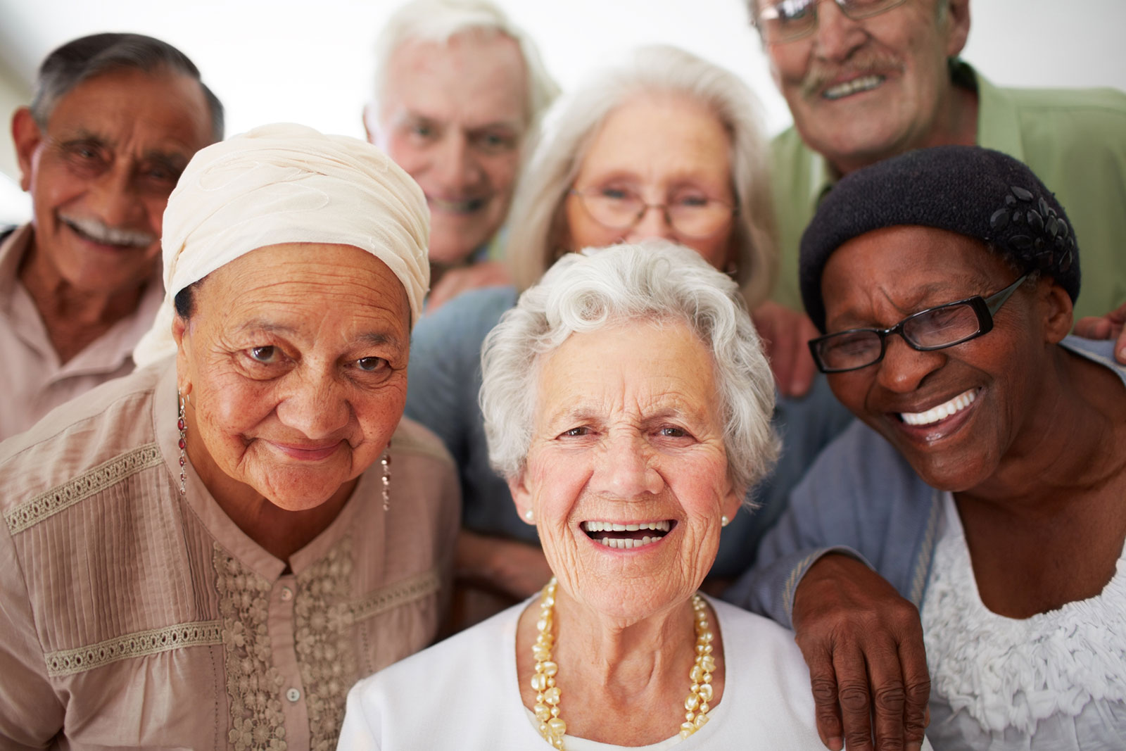 multi-ethnic group of elderly friends posing for the camera